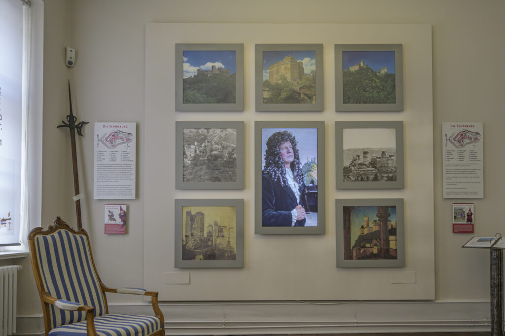 Picture of a man with a knight helmet inside of a grey picture frame surrounded by 7 other pictures.
